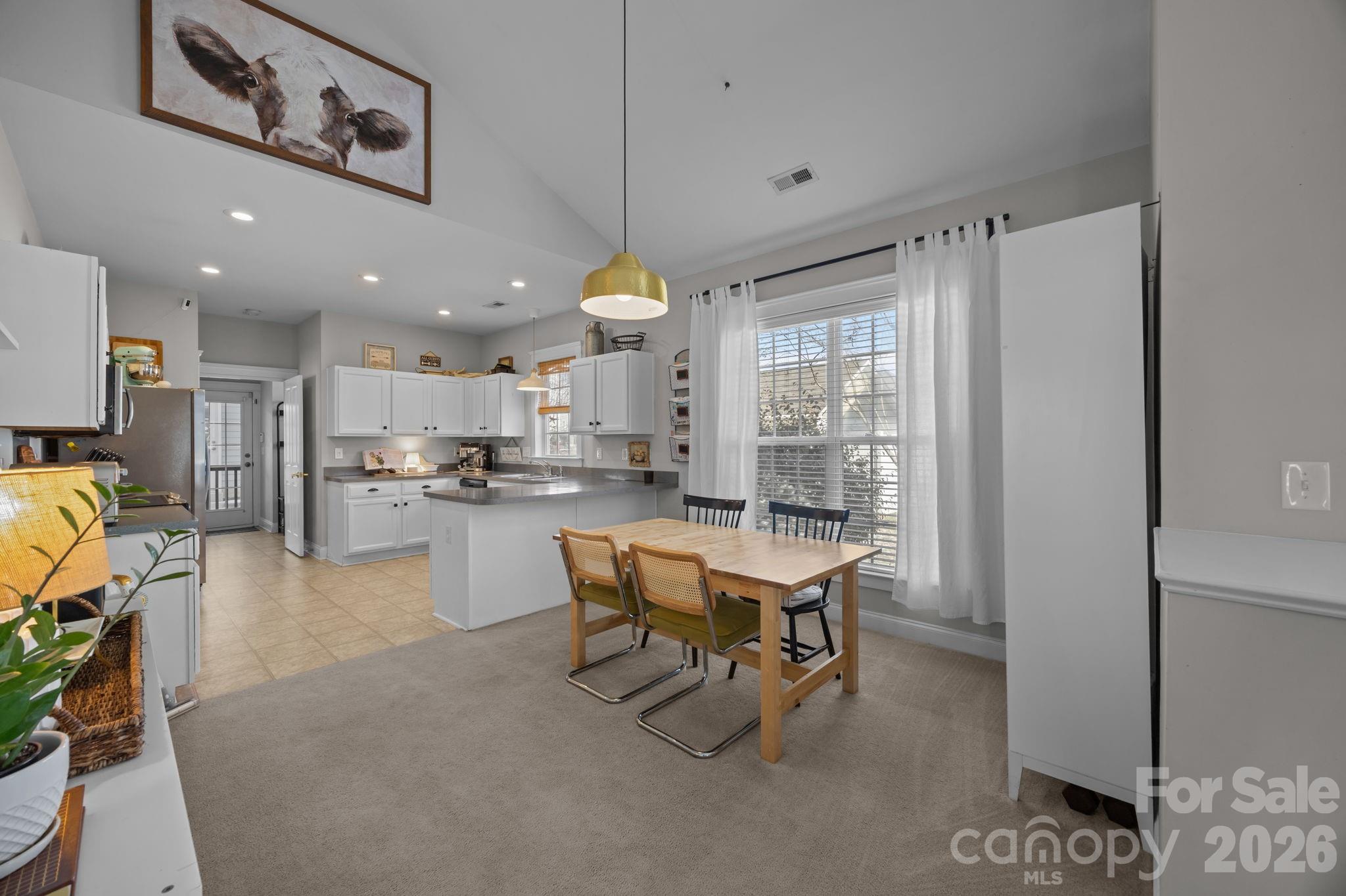 8111 Bud Henderson Road Huntersville, NC 28078 - Photo 8 of 39 a room with stainless steel appliances kitchen island granite countertop furniture and a view of kitchen