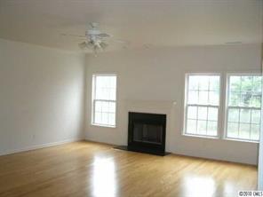2026 Durand Road Fort Mill, SC 29715 - Photo 2 of 13 an empty room with windows and fireplace