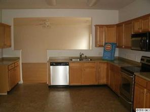 2026 Durand Road Fort Mill, SC 29715 - Photo 6 of 13 a kitchen with a stove top oven a sink a counter space and cabinets