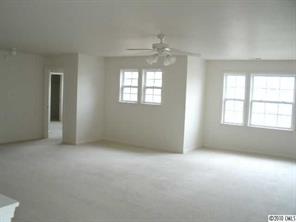 2026 Durand Road Fort Mill, SC 29715 - Photo 9 of 13 an empty room with windows and chandelier fan