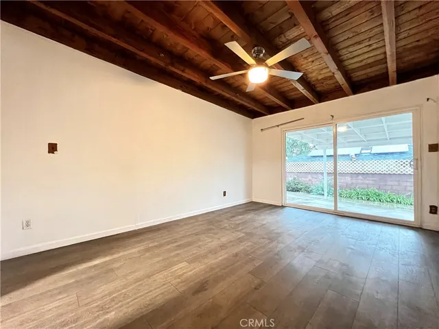 a view of a room with wooden floor and windows