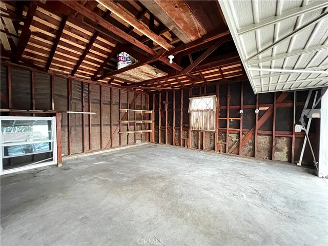 a view of an empty room with wooden roof