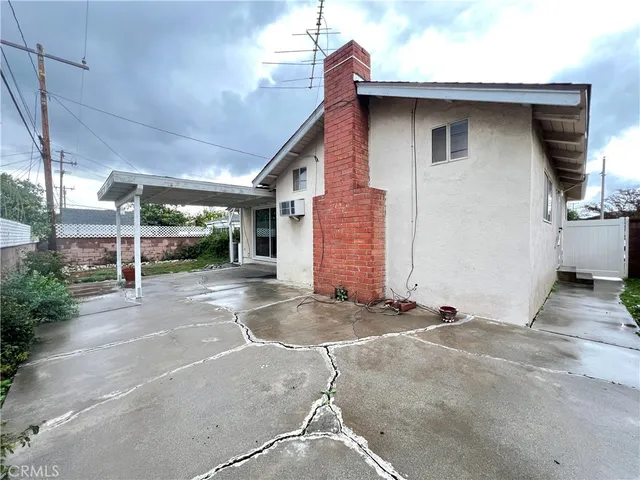 a backyard of a house with plants and outdoor seating