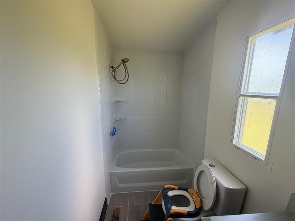 222 Hix Road Cleburne, TX 76031 - Photo 16 of 27 a bathroom with a bathtub and shower