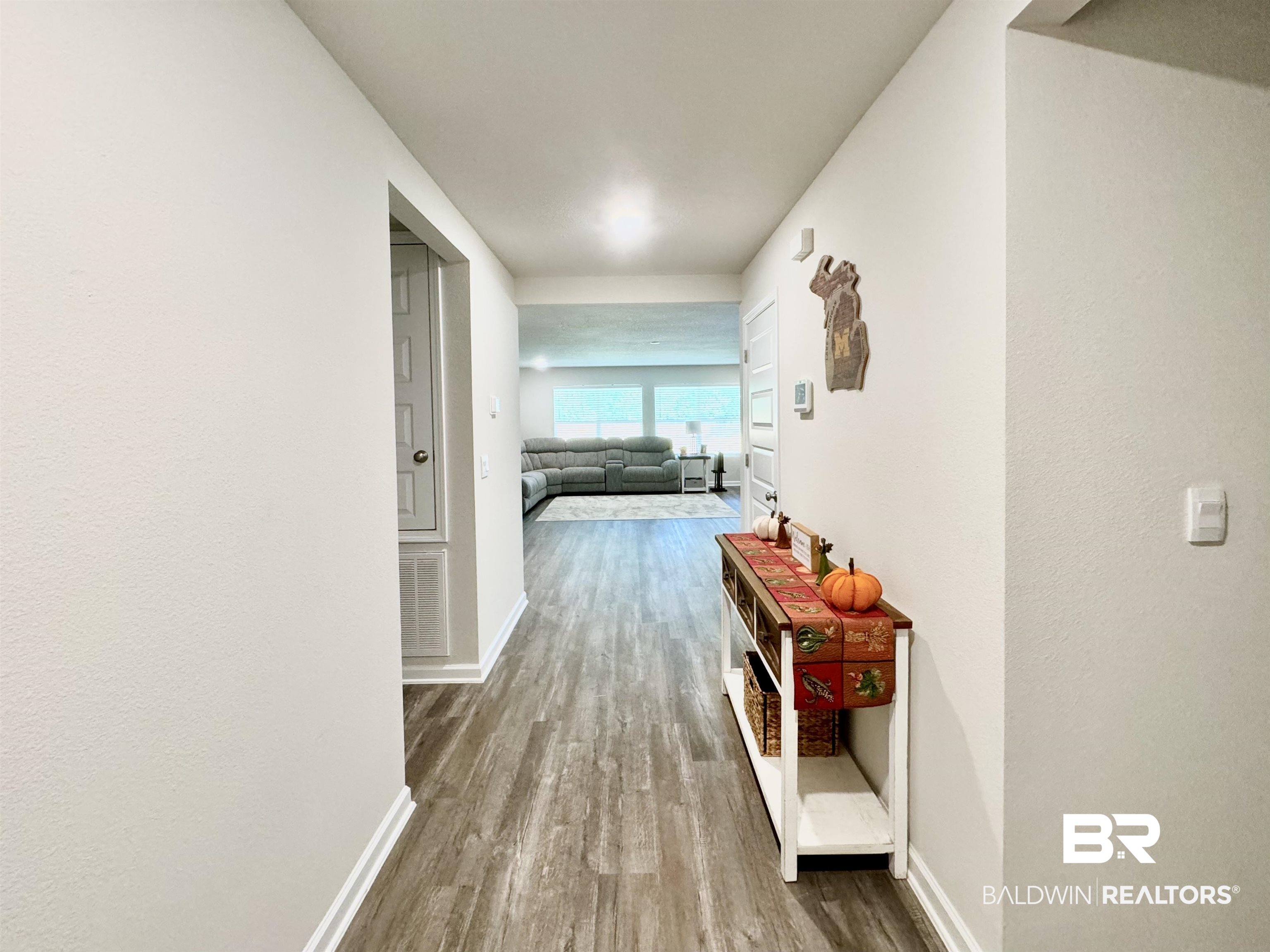 24216 Ringneck Loop Elberta, AL 36530 - Photo 19 of 23 Hallway with light wood-type flooring and baseboards