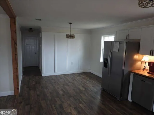 a view of a refrigerator in kitchen and wooden floor