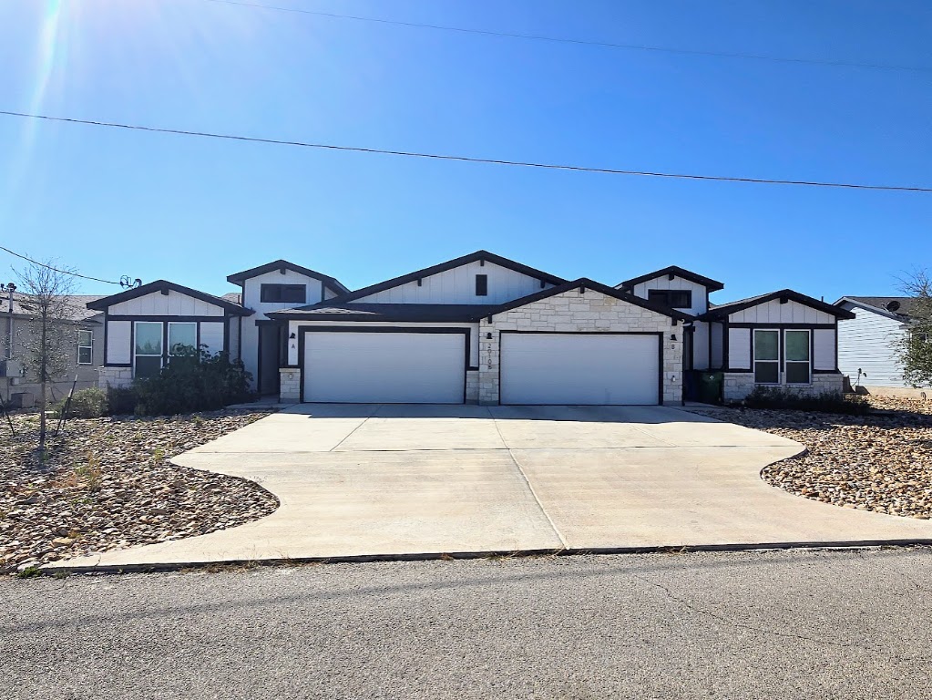 20105 Park Strip Street, Unit A B Lago Vista, TX 78645 - Photo 1 of 26 a front view of a house with a yard and garage