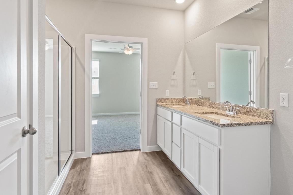 20105 Park Strip Street, Unit A B Lago Vista, TX 78645 - Photo 11 of 26 a bathroom with a granite countertop sink and a mirror