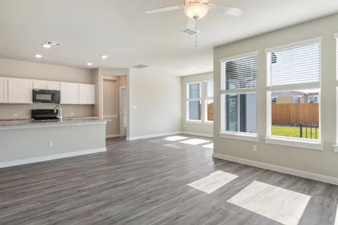 a view of a kitchen with a stove cabinets and wooden floor