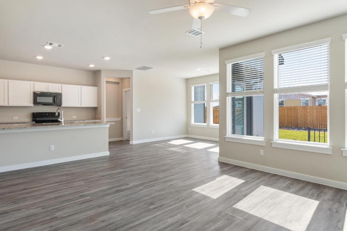 20105 Park Strip Street, Unit A B Lago Vista, TX 78645 - Photo 5 of 26 a view of a kitchen with a stove cabinets and wooden floor
