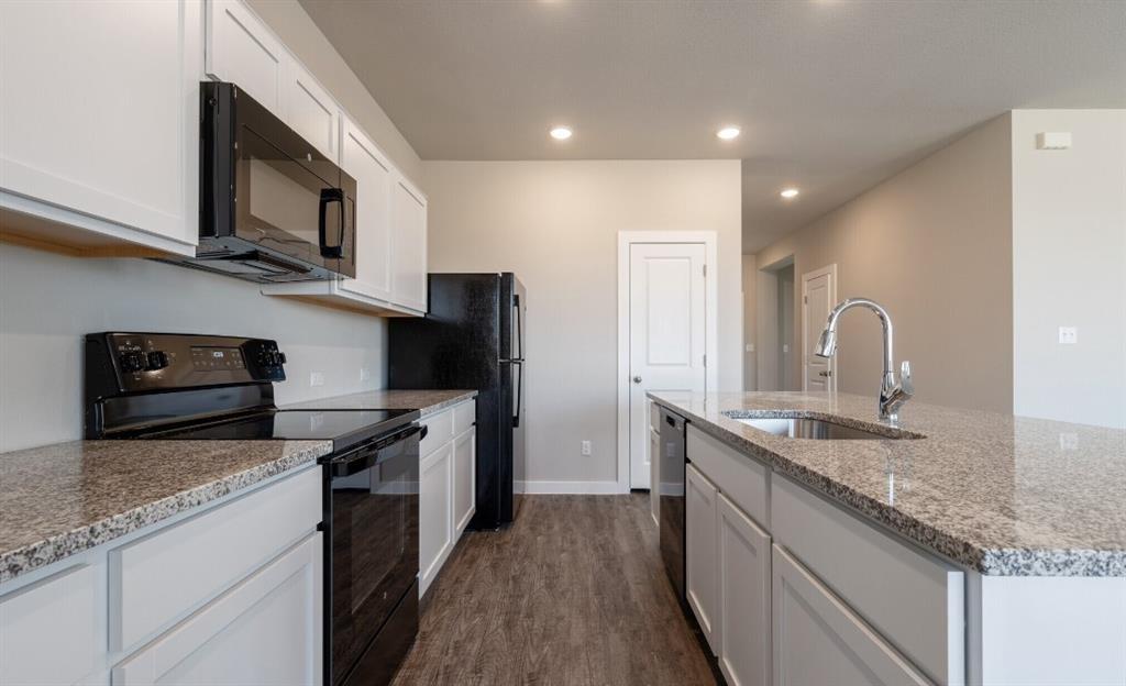 20105 Park Strip Street, Unit A B Lago Vista, TX 78645 - Photo 7 of 26 a kitchen with stainless steel appliances granite countertop a sink stove and refrigerator