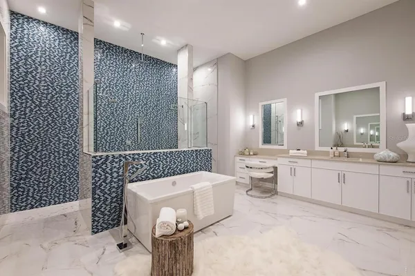 a bathroom with a bathtub sink mirror and toilet