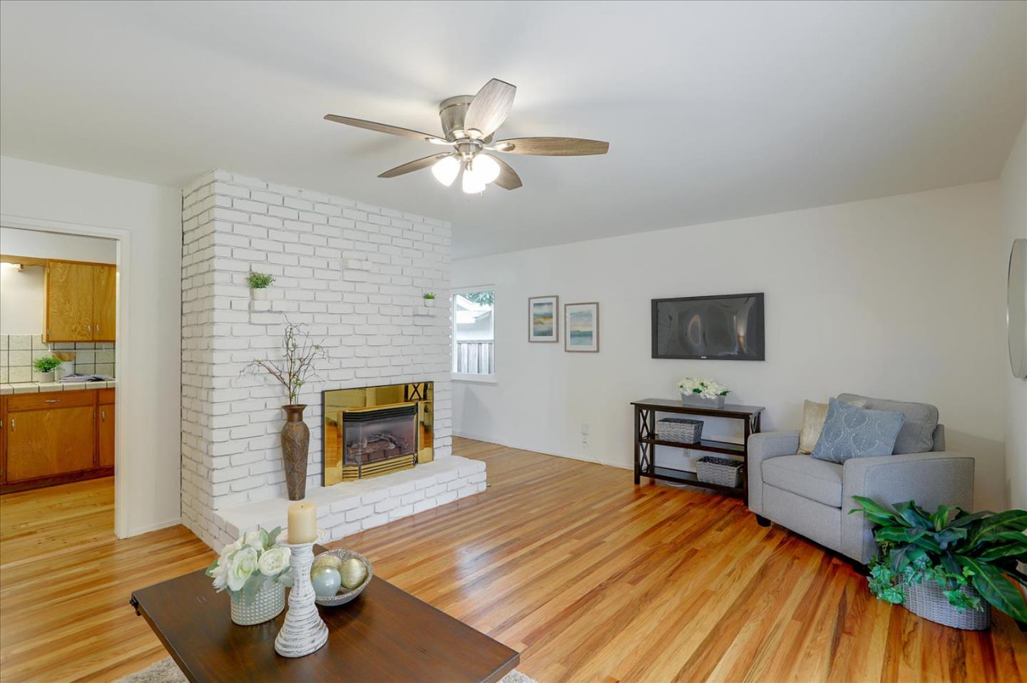 345 Silvera Street Milpitas, CA 95035 - Photo 11 of 38 a living room with furniture and a fireplace