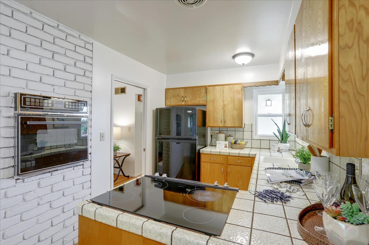 345 Silvera Street Milpitas, CA 95035 - Photo 14 of 38 a kitchen with granite countertop a refrigerator and a stove top oven