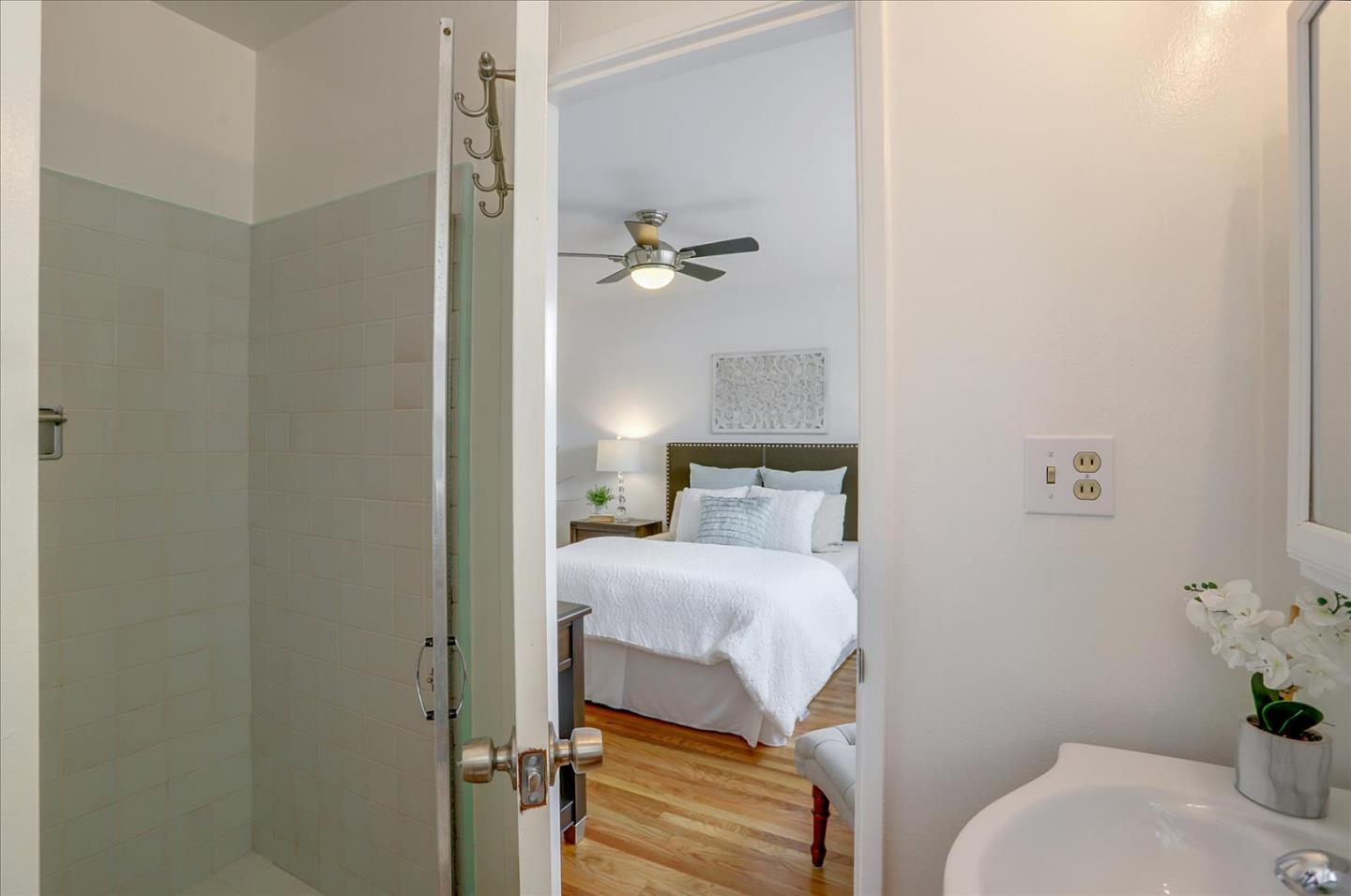 345 Silvera Street Milpitas, CA 95035 - Photo 31 of 38 a bedroom with a bed and a table with potted plant