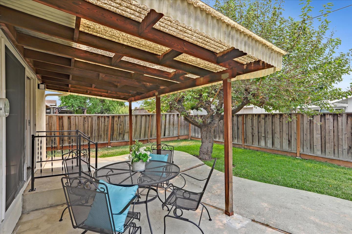 345 Silvera Street Milpitas, CA 95035 - Photo 33 of 38 a view of a patio with table and chairs under an umbrella with a small yard