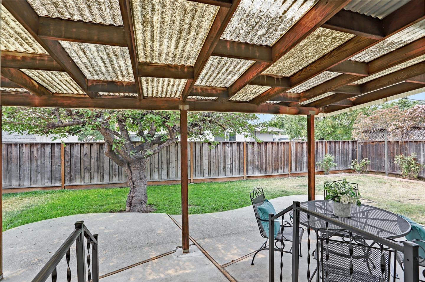345 Silvera Street Milpitas, CA 95035 - Photo 36 of 38 a view of a patio with a table and chairs under a large umbrella