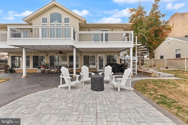 a view of a patio with dining table and chairs
