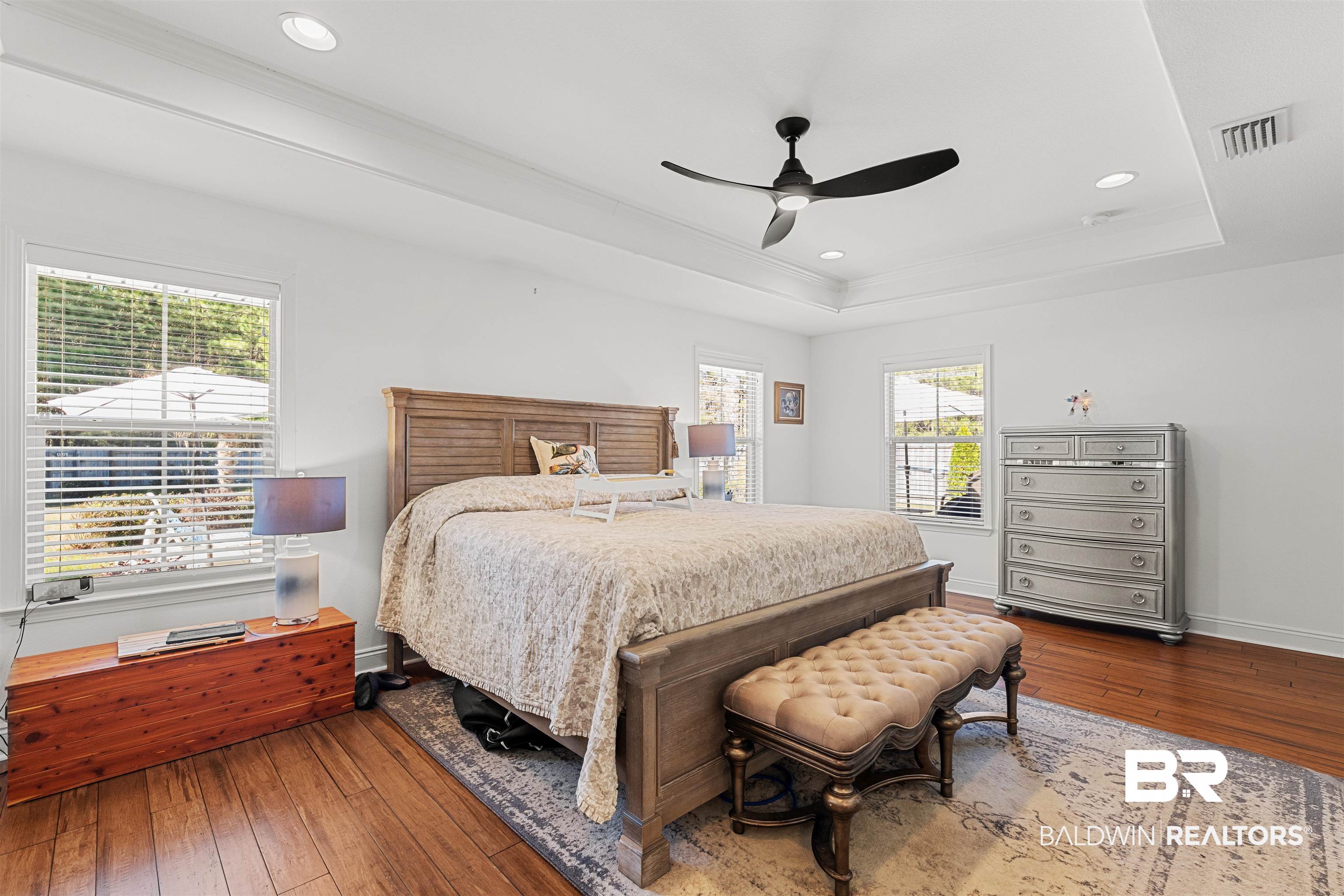 1850 Arcadia Drive Foley, AL 36535 - Photo 19 of 44 Bedroom with a tray ceiling, baseboards, visible vents, and hardwood / wood-style floors