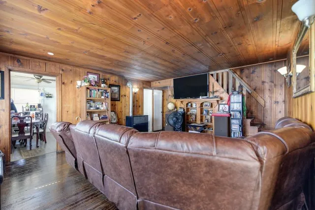 a view of a livingroom with furniture window and wooden floor