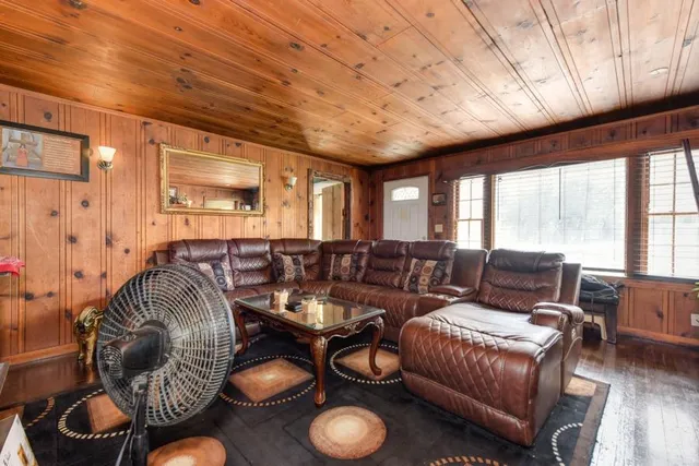 a kitchen with stainless steel appliances a microwave a stove a table and white cabinets