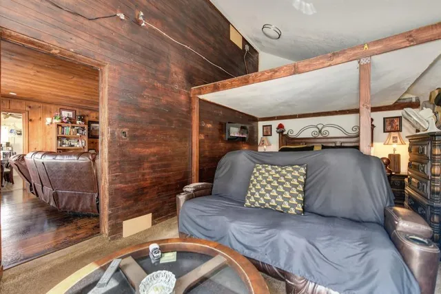 a living room with furniture gym equipment and a window