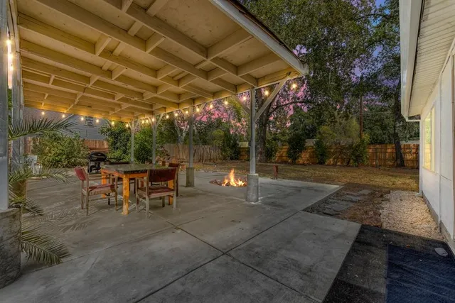 a view of a house with garden and trees