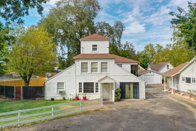 a living room with furniture a flat screen tv and a refrigerator
