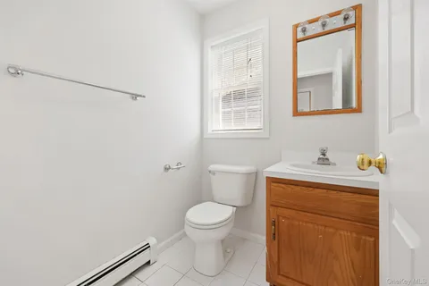 a view of an empty room with wooden floor and windows