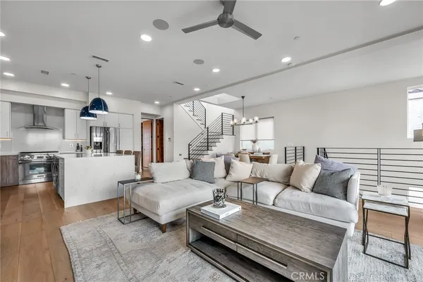 a living room with furniture and kitchen view