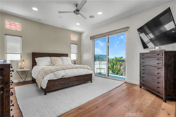 a bedroom with a bed closet and flat tv screen