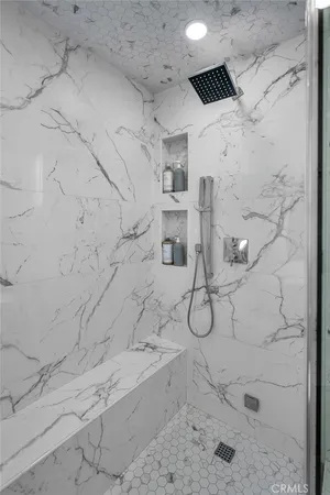 a bathroom with a granite countertop shower and a sink