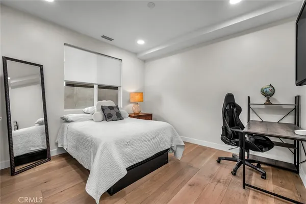 a bedroom with a bed a desk and chair