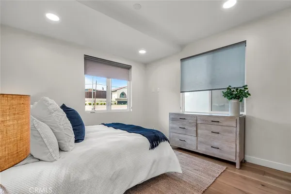 a bedroom with a large bed and a dresser
