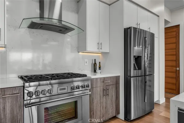 a kitchen with stainless steel appliances granite countertop a stove and a refrigerator