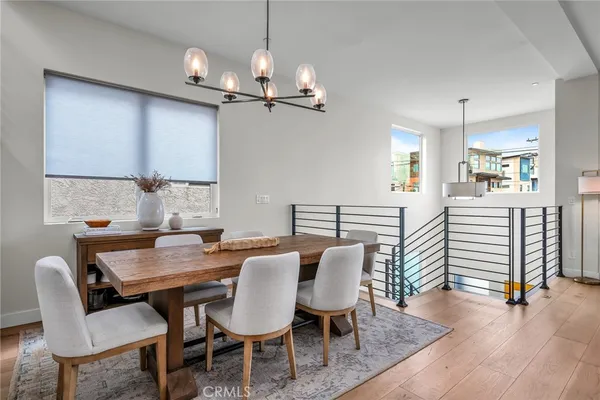 a view of a dining room with furniture wooden floor and chandelier