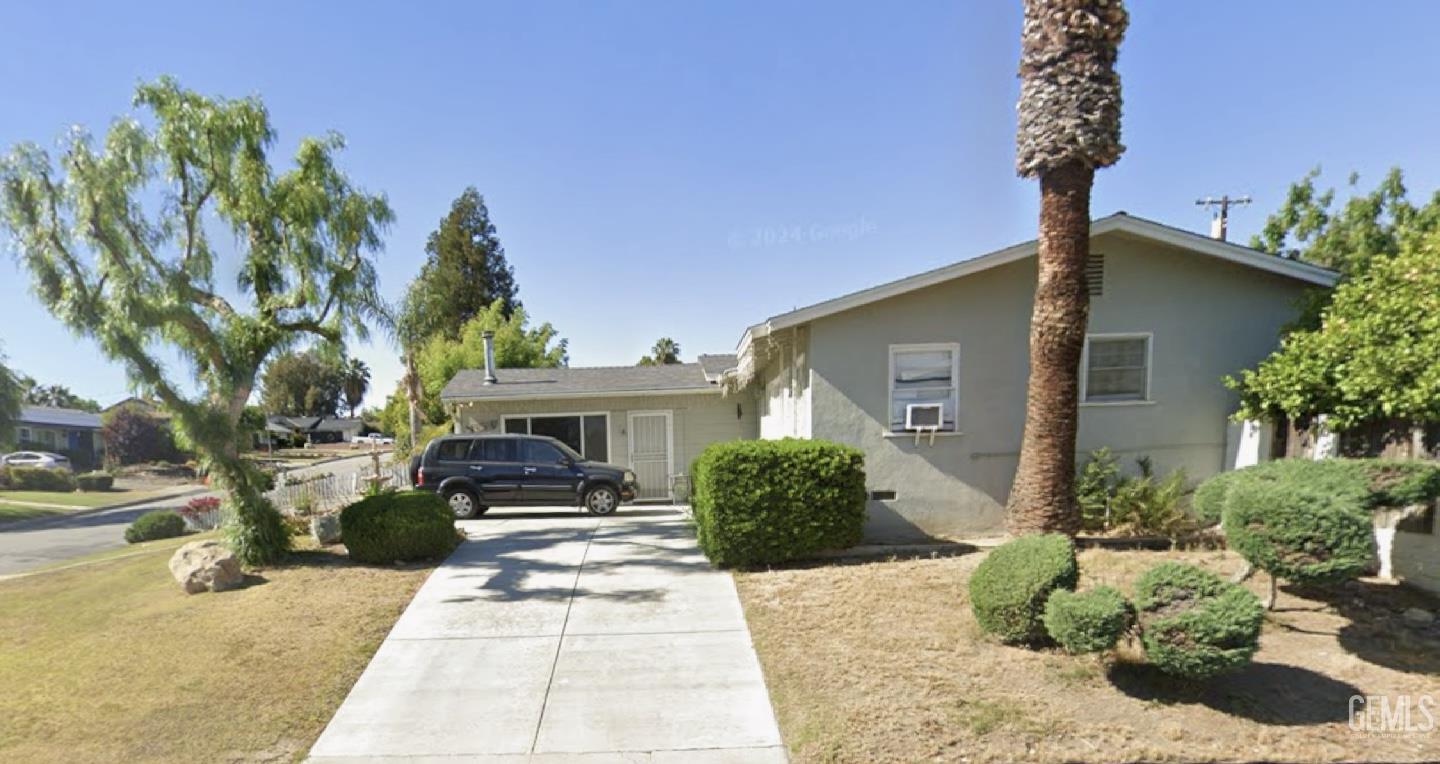 Undisclosed Address Bakersfield, CA 93306 - Photo 2 of 3 a front view of a house with garden
