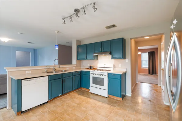 a kitchen with stainless steel appliances granite countertop a stove sink and cabinets