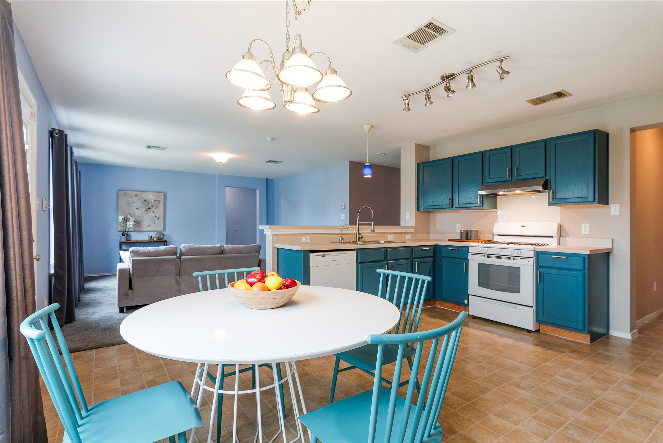 1329 Amberwood Loop Kyle, TX 78640 - Photo 7 of 27 a view of a dining room with furniture a kitchen and chandelier