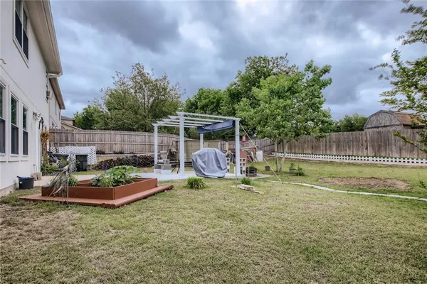a view of backyard with trampoline