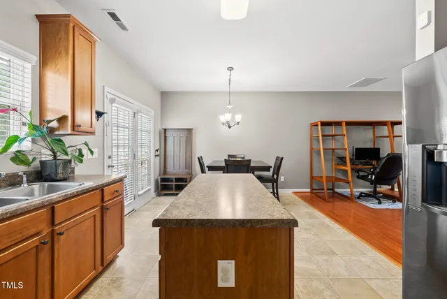a kitchen with stainless steel appliances granite countertop sink stove and refrigerator