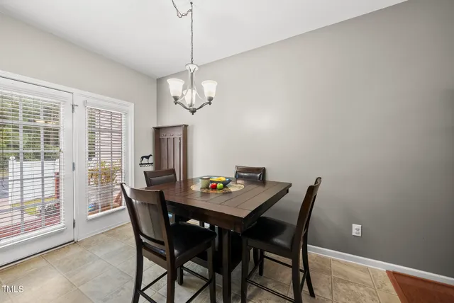 a view of a dining room with a table and chairs