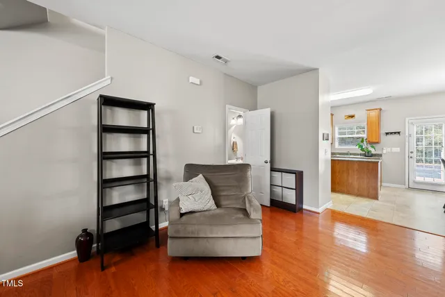 a living room with furniture and wooden floor