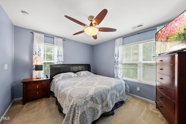 a bedroom with a bed dresser and a window