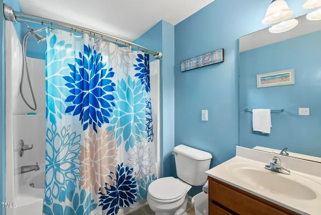 a bathroom with a sink mirror and toilet