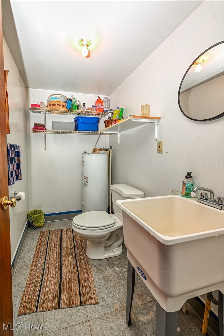 893 Industry Road Atwater, OH 44201 - Photo 34 of 50 Bathroom featuring water heater, sink, and toilet