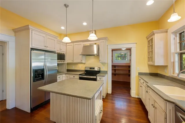 a kitchen with granite countertop a stove and a sink