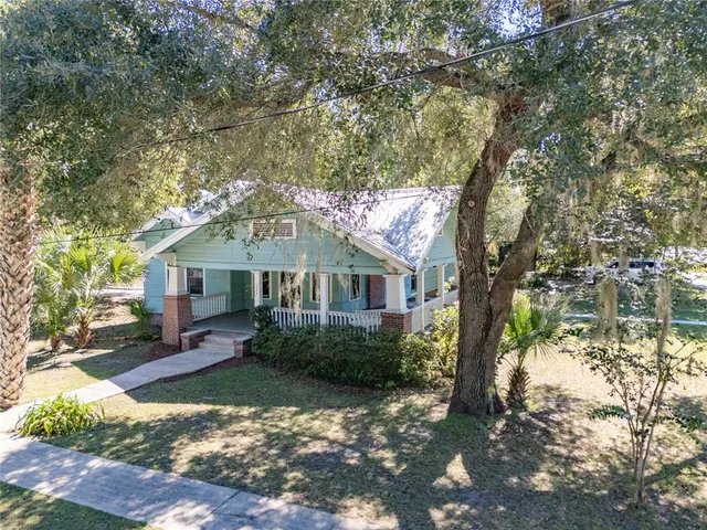 a view of a house with a tree in the background