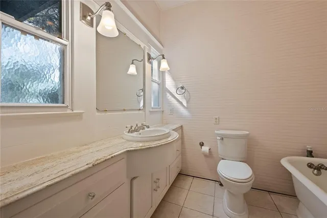 a view of empty room with wooden floor and fireplace