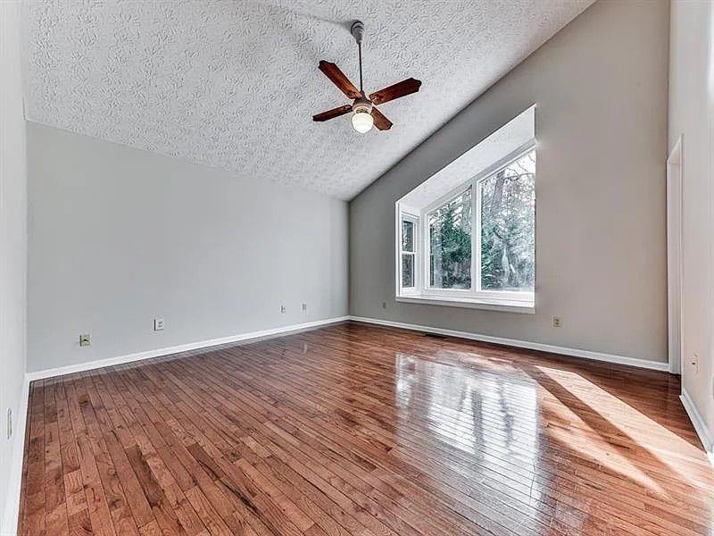 1400 Boxwood Trace Northwest Acworth, GA 30102 - Photo 12 of 23 an empty room with wooden floor fan and windows